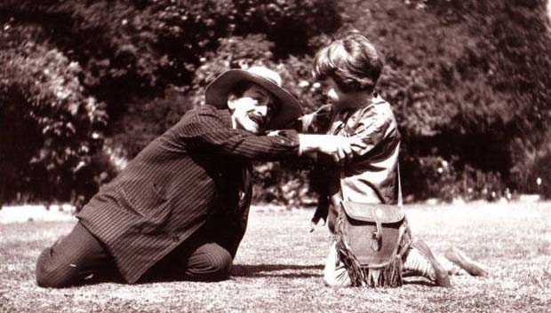 J. M. Barrie (as Hook) and Michael (as Peter Pan) on the lawn at Rustington, August 1906.