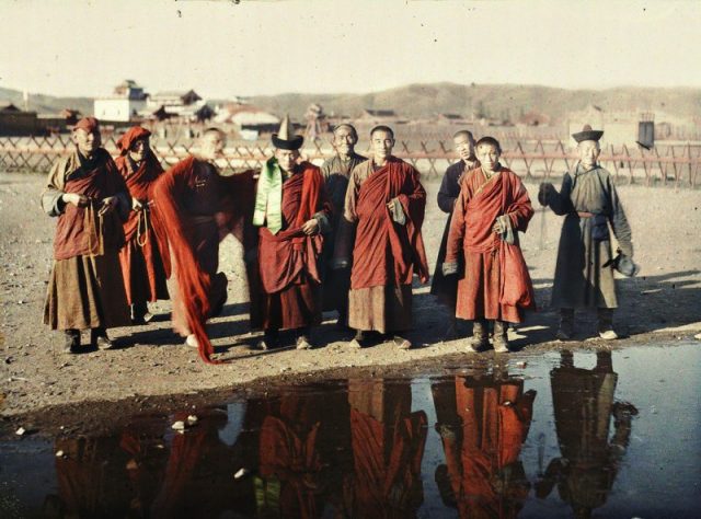 Lamas and another man near the yellow palace, Urga, Mongolia. Autochrome.