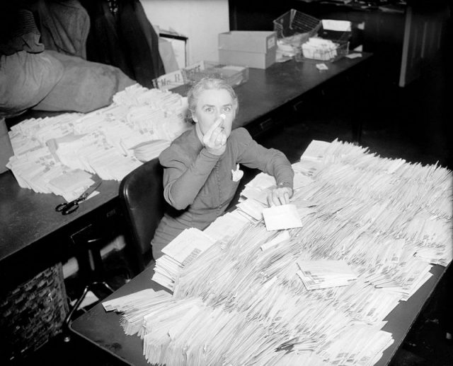 FDR’s personal secretary Missy LeHand with 30,000 letters containing ten-cent contributions to the National Foundation for Infantile Paralysis that arrived at the White House the morning of January 28, 1938.