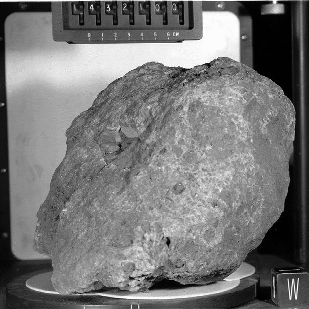 Sample 14321, aka Big Bertha, a 9.0 kg breccia that was collected at Station C1 near the rim of Cone Crater. Photographed in the Lunar Receiving Lab.