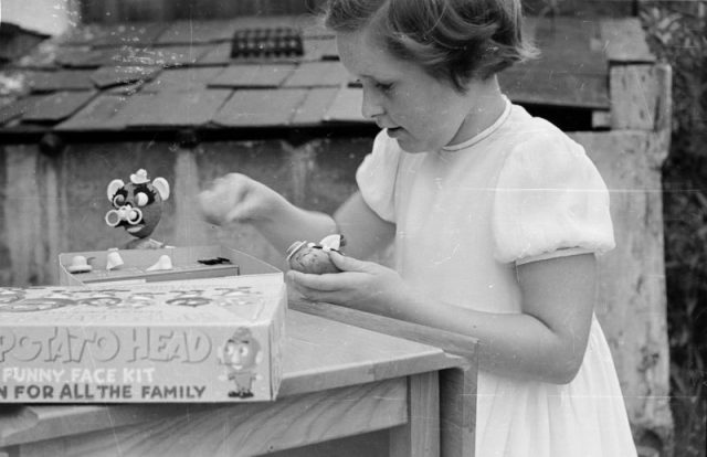 A child playing with a Mr Potato head. Original Publication: Picture Post – 6578 – Cowboys Versus Spacemen – pub. 1953. Photo by Picture Post/Hulton Archive/Getty Images