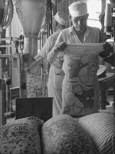 Circa 1939: Workers filling colorfully printed flour sacks which housewives use to make dresses because the labels wash out, at Sunbonnet Sue flour mill. Photo by Margaret Bourke-White/The LIFE Picture Collection/Getty Images