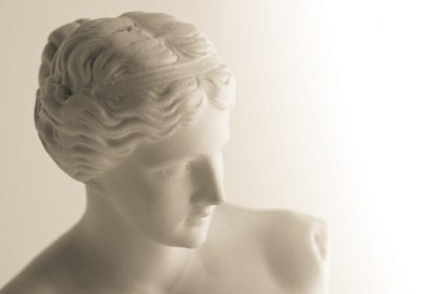 Sepia-toned image of a vintage copy statue of Venus (or Aphrodite) de Milo, a famous Greek sculpture dating back to about 100 BC and found in 1820 on the Aegean island of Milos. The original statue is in the Louvre museum in Paris.