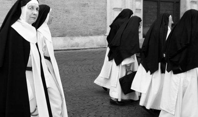 Rome, Italy – May 1, 2009: A group of nuns in traditional habits walking in Rome’s Trastevere neighborhood.