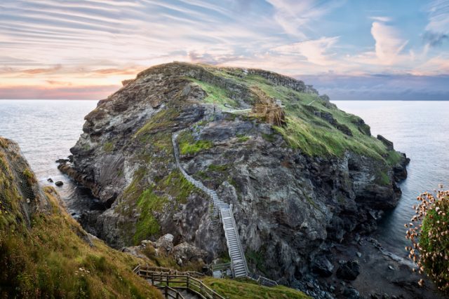 Tintagel, United Kingdom – August 12, 2016: View of Tintagel Island and legendary Tintagel castle ruins at sunset.