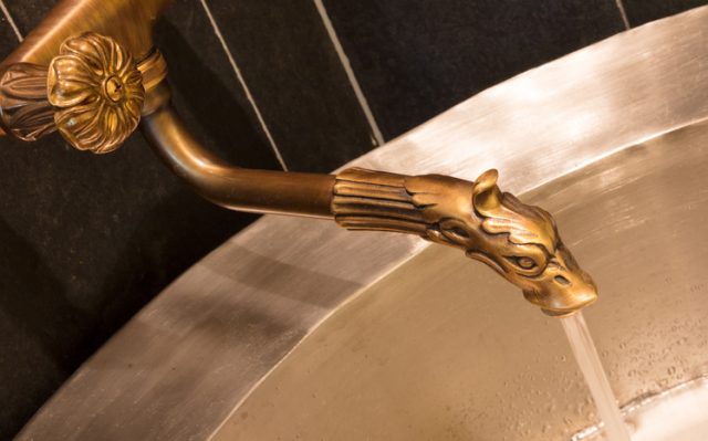 Unique brass faucet – Interior of a sauna.