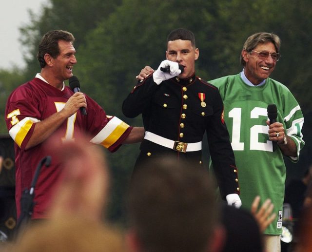 Former NFL quarterbacks Joe Theismann of the Washington Redskins and Joe Namath of the New York Jets clown around on stage before the opening of the NFL Kickoff, 2003