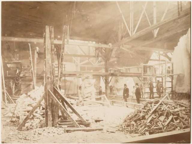 View of the workshop, with models of the Statue of Liberty in the background.