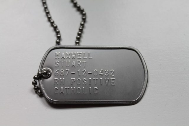 An American dog tag showing the recipient’s last name, first name, Social Security number, blood type, and religion. Photo by dog-tag.de CC BY-SA 3.0
