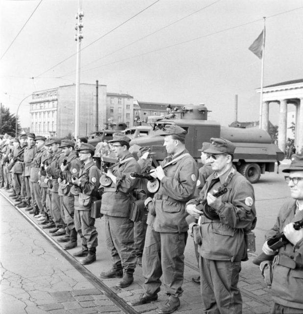 East German Combat Groups of the Working Class close the border on August 13, 1961 in preparation for the Berlin Wall construction. Photo by Bundesarchiv, Bild 183-85458-0002 / Junge, Peter Heinz / CC-BY-SA