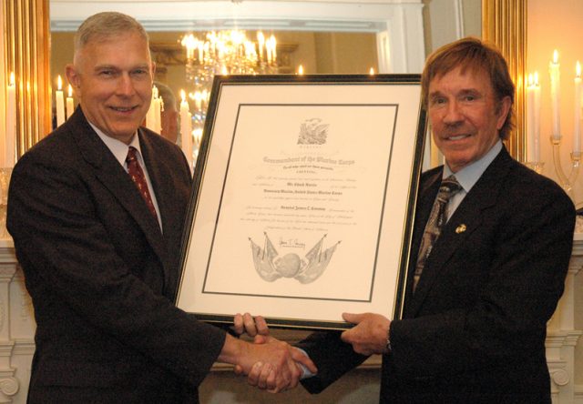 General James Conway, 34th Commandant of the Marine Corps, and Mr. Chuck Norris pose for a photo with the Honorary Marine citation presented to Mr. Norris during a dinner held in his honor on March 28, 2007. The dinner was held at the Home of the Commandants located at Marine Barracks Washington, D.C. Official USMC Photo by Sgt. Christopher M. Tirado