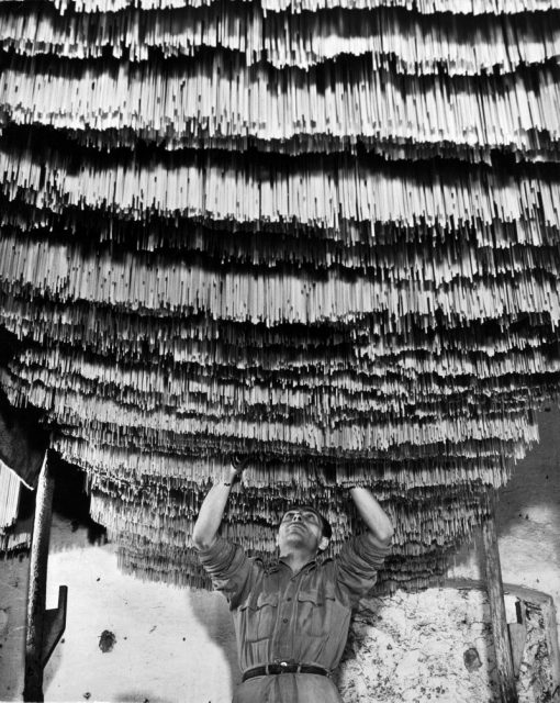 Torre Annunziata, Italy – January 01: Worker at a pasta factory inspecting spaghetti in the drying room. Photo by Alfred Eisenstaedt/The LIFE Picture Collection/Getty Images