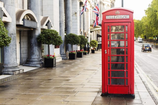 Red British phone booth on the streets of London