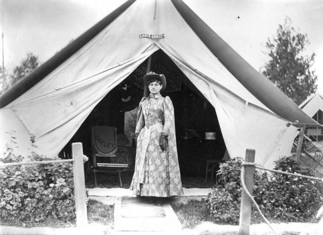 Phoebe Anne ‘Annie Oakley’ Moses poses in front of her tent in a camp for Buffalo Bill’s Wild West Show