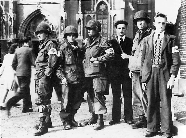 Members of the Eindhoven Resistance with troops of the United States 101st Airborne Division in Eindhoven during Operation Market Garden, September 1944