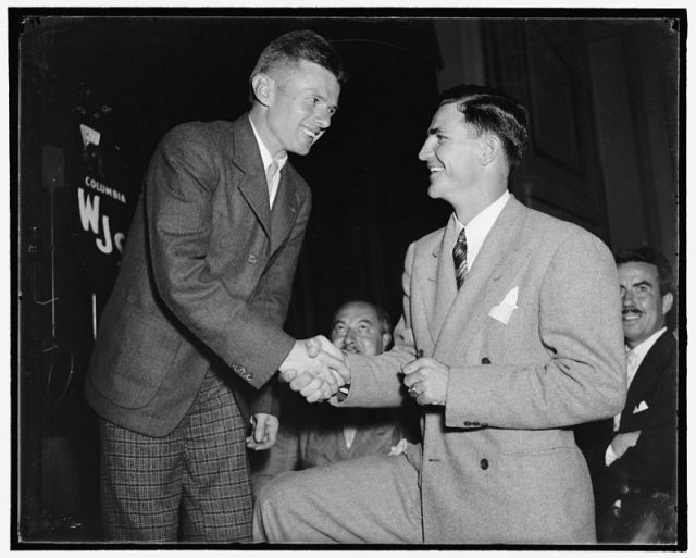 Doug “Wrong Way” Corrigan greets Sammy Baugh, Ace Passer of the Washington Redskins, at a reception at the National Press Club, 1938