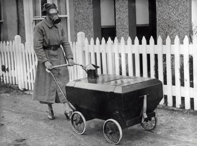 A woman tests a stroller intended to be resistant to gas attacks in Hextable, England in 1938, not long before the outbreak of World War II.