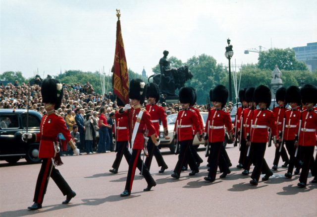 London, England, UK, 1973: Changing of the Guards. Members of the Queens Guard regiment marching in front of Buckingham Palace.