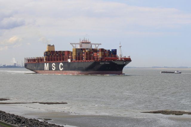 Ultra large container ship MSC Zoe navigates partly unloaded through river Scheldt towards Antwerp