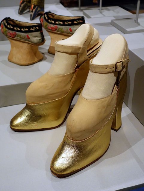 A pair of “trick” platform shoes worn by Mae West in films to make her look taller, which also contributed to her unique walk.