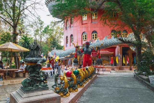 Nakon Pathom, Thailand – February 5, 2018: Religious offerings in the courtyard of the dragon temple Wat Samphran, Nakhon Pathom province, near Bangkok, Thailand