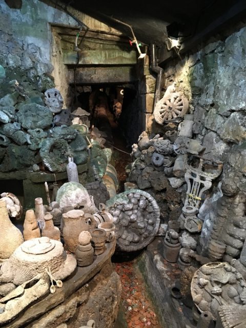 The Petrifying Well at the Matlock Bath Aquarium with objects that have been coated by minerals from the water.