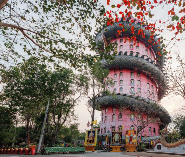 Giant Chinese dragon encircling a red temple at Wat Samphran in Nakhon Pathom province, near Bangkok, Thailand
