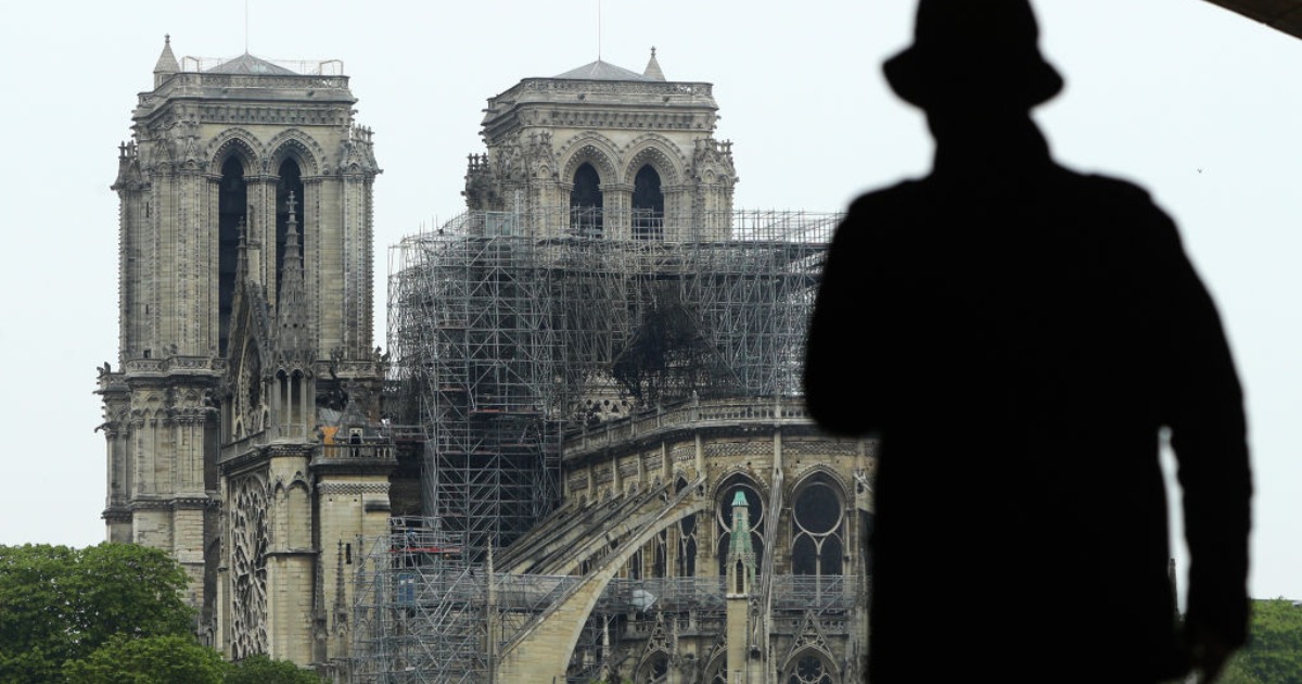 Man in front of Notre Dame cathedral. (Photo by Dan Kitwood/Getty Images)