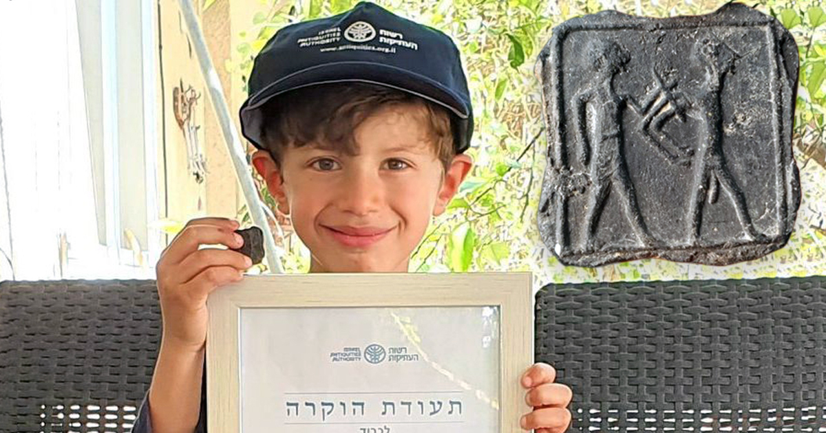 6-yr-old Imri Elya was awarded a "good citizenship" certificate for discovering a small Canaanite tablet near an Israeli archaeological site. (Emil Aladjem, Israel Antiquities Authority)