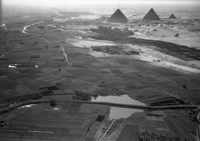 January 24, 1938. Cairo, Egypt: Another view of the pyramids and the border of the cultivated Nile valley.