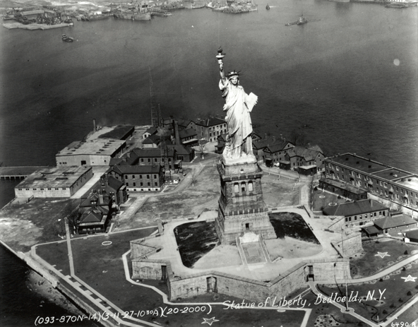 Bedloe’s Island in 1927, showing the statue and army buildings. The eleven-pointed walls of Fort Wood, which still form the statue’s base, are visible.
