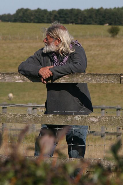 Arthur Uther Pendragon standing outside of the Stonehenge monument fence. Chris Brown – CC BY-SA 2.0