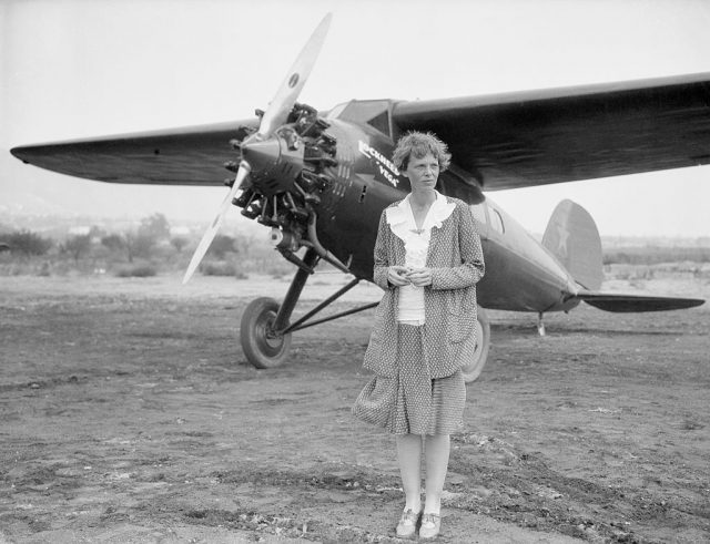 Amelia Earhart at Long Beach, Ca, with her plane. Undated b/w photo.