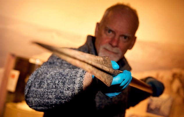 Neil Mahrer, Jersey Museum’s conservator, with the spear. Image credit – Rob Currie/Jersey Evening Post/SWNS