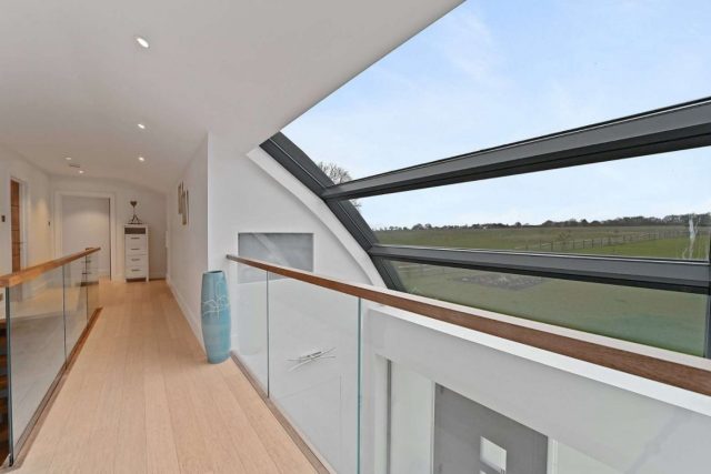A balcony offers views over the owner’s 2.33 acres of land. Image Courtesy of Savills.