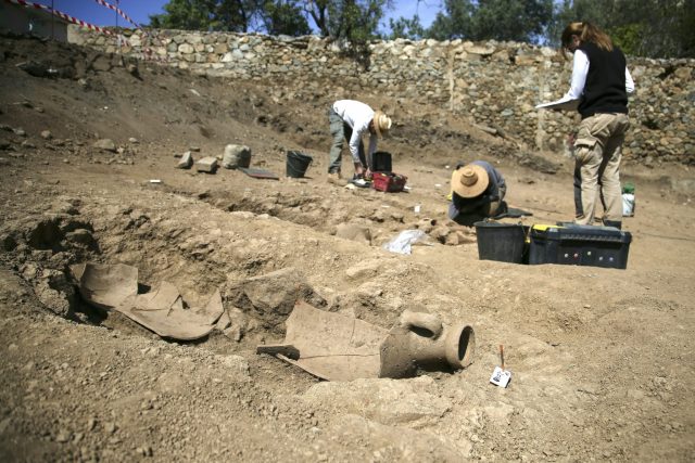 archaeologists excavating large necropolis
