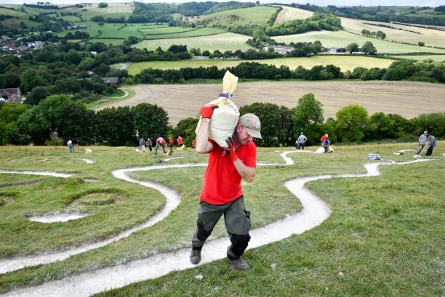 volunteers cleaning The Cerne Giant