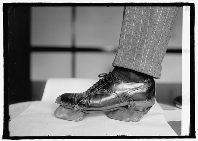 Cow shoes on the bottom of a person's shoe