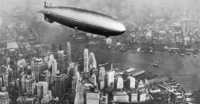 The Hindenburg airship (LZ-129) flies over the Hudson River and downtown Manhattan, New York City, in 1936.