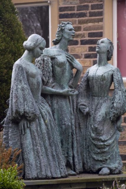 Bronze statue of the Bronte sisters in the grounds of the Parsonage Museum.