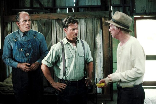 John Malkovich, Gary Sinise, and Ray Walston on the set of 'Of Mice And Men' (1992).