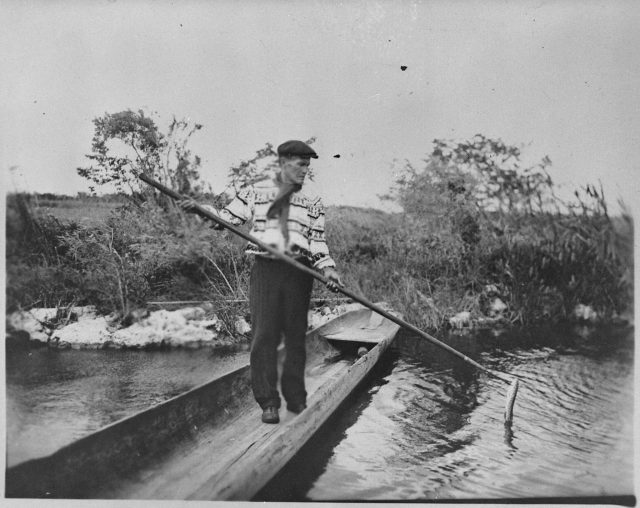A Seminole spearing a garfish from a dugout, Florida, 1930
