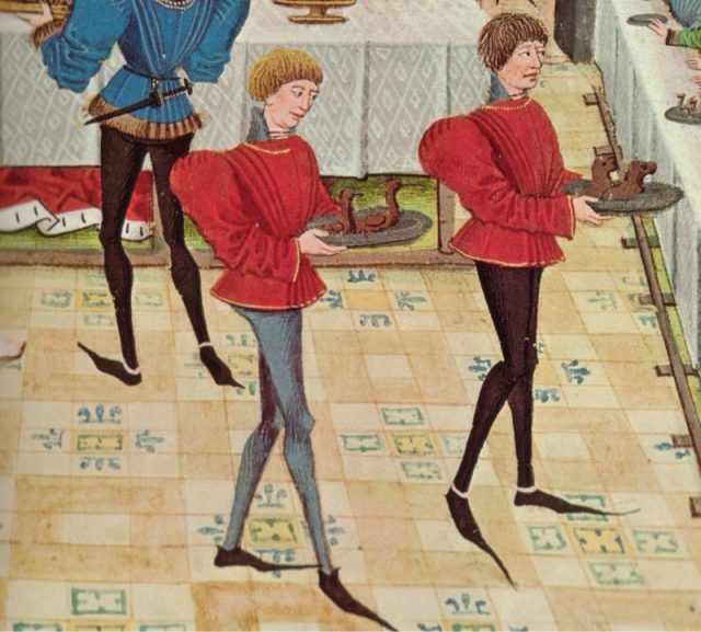 Detail from a medieval manuscript showing servants wearing pointy shoes