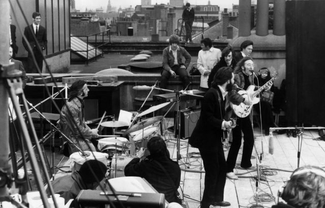the Beatles performing their last live public concert on the rooftop of the Apple Organization building for director Michael Lindsey-Hogg's film documentary, 'Let It Be,' on Savile Row, London, England.