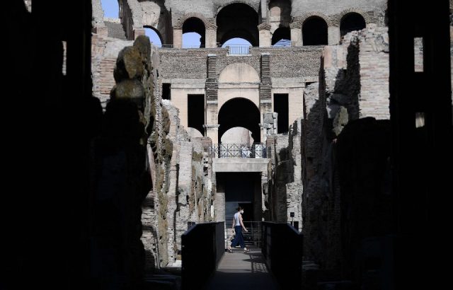 A visitor walks inside the Colosseum, which restoration of arena's underground labyrinth has been sponsored by fashion group Tod's