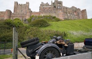 A replica SS motorbike is driven into the grounds of Bamburgh Castle in Northumberland, which is being used as a filming location for what is believed to be the new Indiana Jones 5 movie.