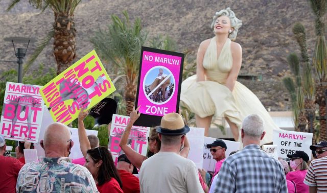 Protestors surround the 'Forever Marilyn' statue