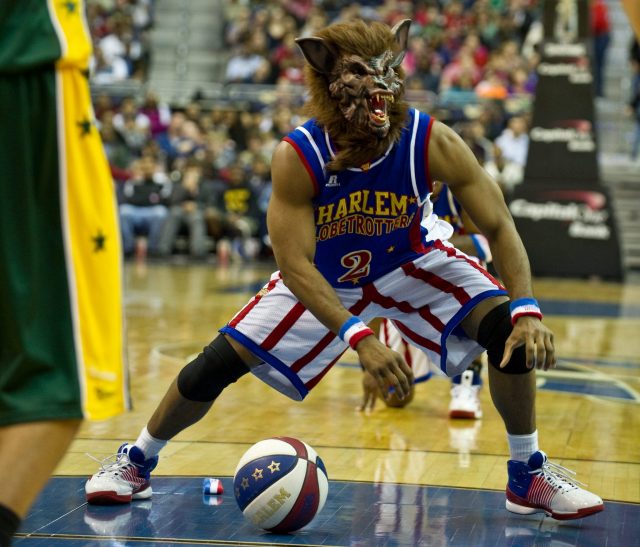 Dizzy Grant of the Harlem Globetrotters wears a werewolf mask during a game against the Washington Generals