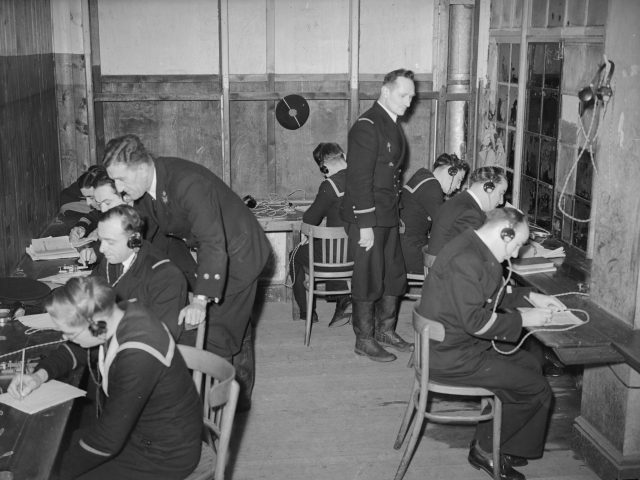 Free French naval recruits learning to send and receive Morse code at an English naval training depot on the east coast.