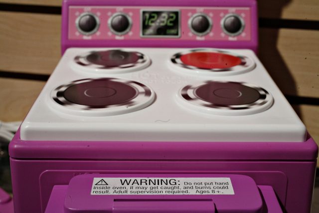 An Easy Bake Oven sits on display in the Hasbro showroom during the International Toy Fair, Monday, Feb. 12, 2007 in New York. The warning sticker and a cover over the oven door are improvements made to the oven following a recall of nearly 1 million units to avoid children being able to stick their hand inside the oven and possibly burn themselves.